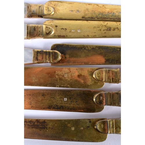 1104 - A SET OF SIX ANTIQUE SILVER GILT AND MOTHER OF PEARL KNIVES. 203 grams. 20cm long. (6)