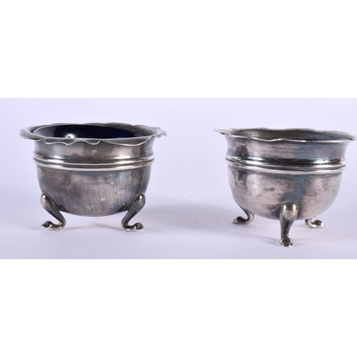 1107 - A PAIR OF ANTIQUE SILVER SALTS. 117 grams inc glass. 5.75 cm wide.