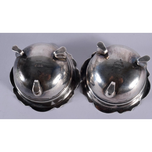 1107 - A PAIR OF ANTIQUE SILVER SALTS. 117 grams inc glass. 5.75 cm wide.