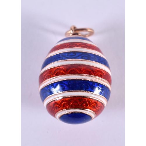 1113 - A RUSSIAN 14CT GOLD AND ENAMEL EGG PENDANT. 12.5 grams. 2.5 cm x 1.75 cm.