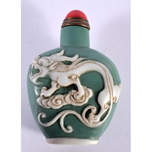 1132 - A GREEN PEKING GLASS SNUFF BOTTLE OVERLAID WITH DRAGONS.  7.6 cm x 5.3cm x 3cm