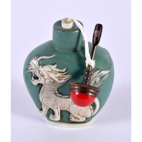 1132 - A GREEN PEKING GLASS SNUFF BOTTLE OVERLAID WITH DRAGONS.  7.6 cm x 5.3cm x 3cm