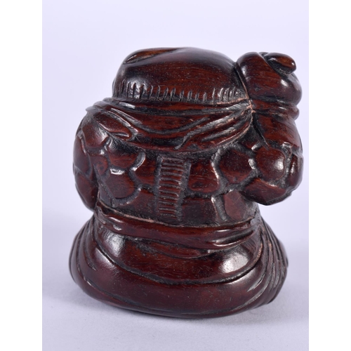 1135 - A JAPANESE CARVED HARDWOOD NETSUKE IN THE FORM OF A SEATED MALE. 4.8 cm x 4.3cm x 4.2 cm