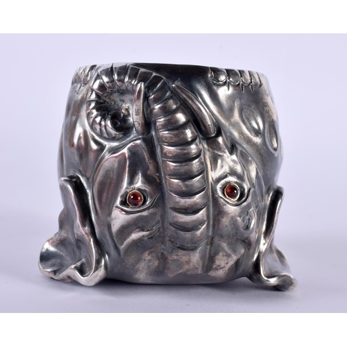 1142 - A CONTINENTAL SILVER ELEPHANT STIRRUP CUP WITH GILT INTERIOR.  Stamped 88, 9cm x 7cm, weight 279g