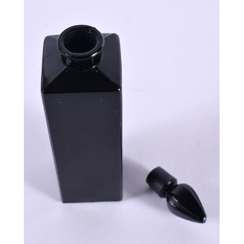 1144 - A CASED FRENCH BLACK GLASS SCENT BOTTLE.  10cm x 2.5cm x 2.5cm (bottle)