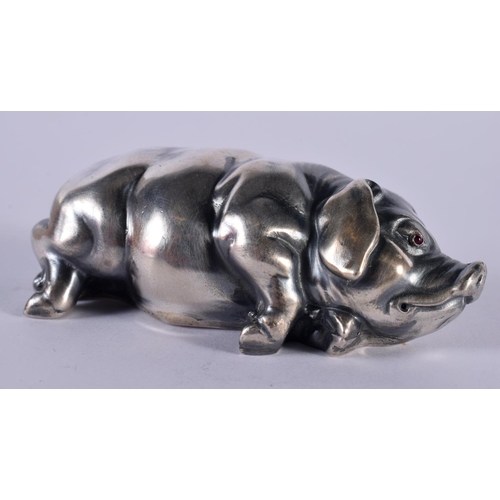 1146 - A CONTINENTAL SILVER PIG WITH GEN SET EYES.  Stamped 84, 7cm x 3.5cm x 2.3cm, weight 42.5g