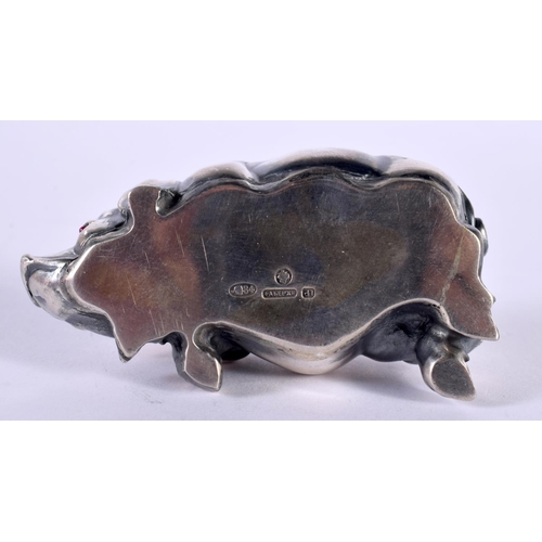 1146 - A CONTINENTAL SILVER PIG WITH GEN SET EYES.  Stamped 84, 7cm x 3.5cm x 2.3cm, weight 42.5g