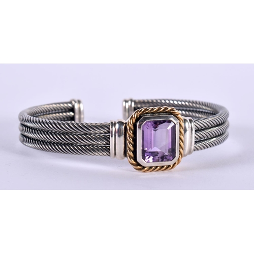 1147 - A SILVER CUFF BANGLE WITH A 14CT GOLD RIM SURROUNDING AN AMETHYST,  Stamped 925 and 14K, 7.7cm x 6.7... 