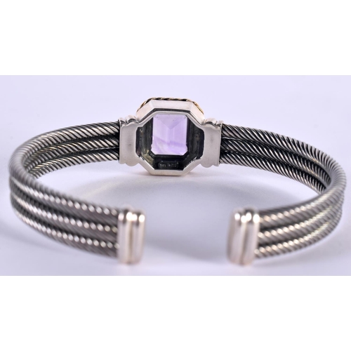 1147 - A SILVER CUFF BANGLE WITH A 14CT GOLD RIM SURROUNDING AN AMETHYST,  Stamped 925 and 14K, 7.7cm x 6.7... 