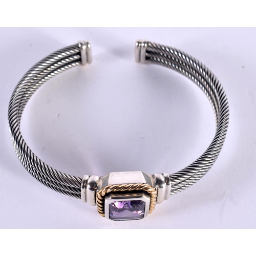 1147 - A SILVER CUFF BANGLE WITH A 14CT GOLD RIM SURROUNDING AN AMETHYST,  Stamped 925 and 14K, 7.7cm x 6.7... 