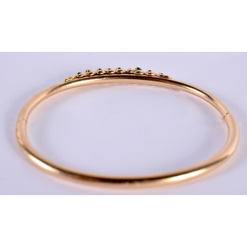 1150 - A 14CT GOLD BANGLE SET WITH EMERALDS AND DIAMONDS.  Stamped 14K, 5.8 cm x 5cm, weight 7.5g