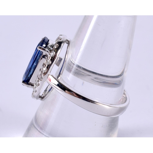 1185 - AN 18CT WHITE GOLD RING SET WITH A SAPPHIRE SURROUNDED BY A BEZEL OF DIAMONDS.  Size O, Stamped 750,... 