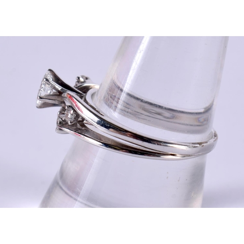 1188 - A 14CT WHITE GOLD RING SET WITH 1 LARGE AND 4 SMALL DIAMONDS.  Size O, total carats 0.5, stamped 14K... 