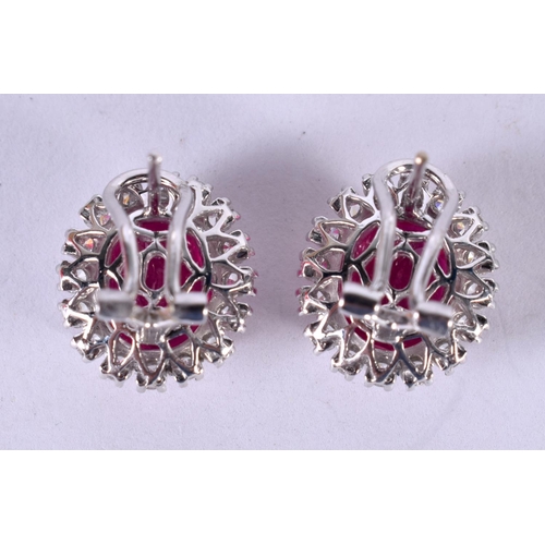 1198 - A PAIR OF 14CT WHITE GOLD EARRINGS SET WITH A RUBY SURROUNDED BY A DIAMOND BEZEL.  STAMPED 14k 585, ... 