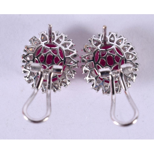 1198 - A PAIR OF 14CT WHITE GOLD EARRINGS SET WITH A RUBY SURROUNDED BY A DIAMOND BEZEL.  STAMPED 14k 585, ... 