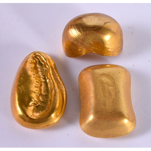 1244 - THREE YELLOW METAL WEIGHTS WITH CHINESE DECORATION (3)