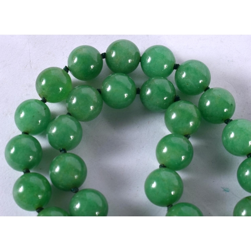 1249 - A GREEN JADE BEAD NECKLACE.  88 cm long, Bead size 11.2mm, weight 155g