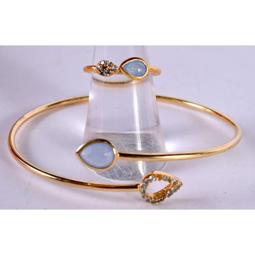 1275 - A SILVER GILT AND GEM SET MATCHING BANGLE AND RING.  Stamped 925, Ring size N, Bangle internal 6 cm ... 