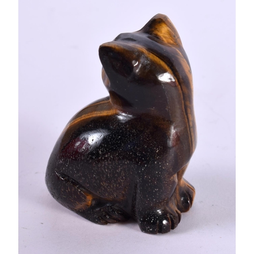 1279 - A CARVED TIGERS EYE CAT WITH GEM SET EYES.  5.8 cm x 4.4cm x 3.1cm, weight 101.6g