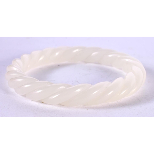 1290 - A CHINESE WHITE JADE TWIST BANGLE.  Internal 6.1cm, weight 42.4g