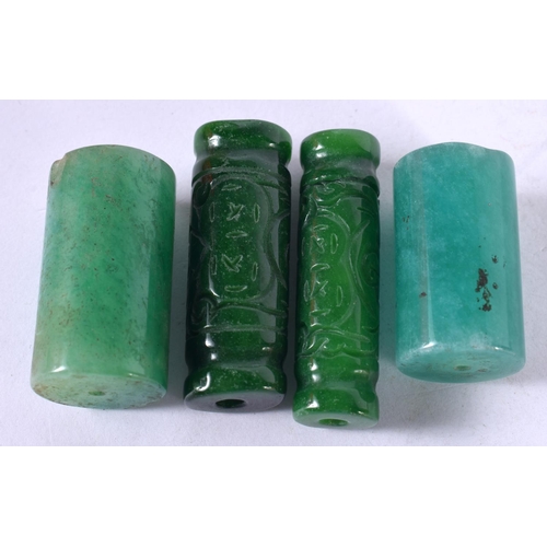 1294 - FOUR JADE BEADS.  Largest 3.6 cm x 2 cm, total weight 86g (4)