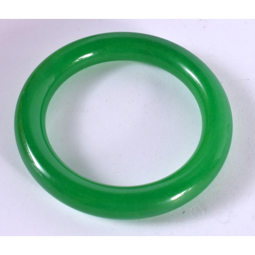 1299 - AN APPLE GREEN JADE BANGLE.  Internal 6.1cm, weight 72.8g