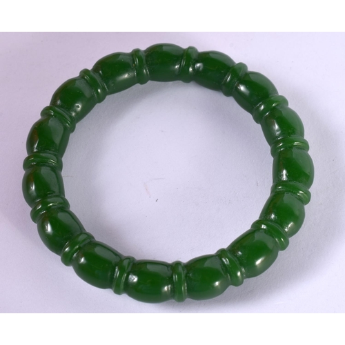 1300 - A RIBBED GREEN JADE BANGLE.  Internal 5.7cm, weight 43.7g