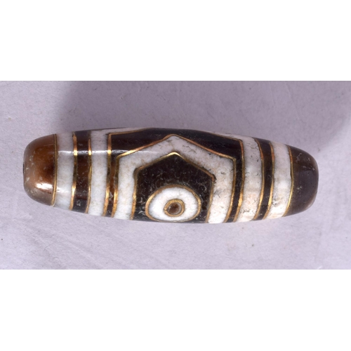 1310 - A TIBETAN GOLD INLAID AGATE ZHU BEAD. 8.4 grams. 4 cm x 1 cm.