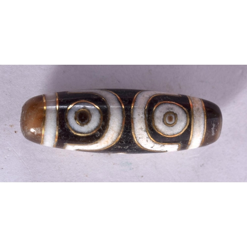 1310 - A TIBETAN GOLD INLAID AGATE ZHU BEAD. 8.4 grams. 4 cm x 1 cm.