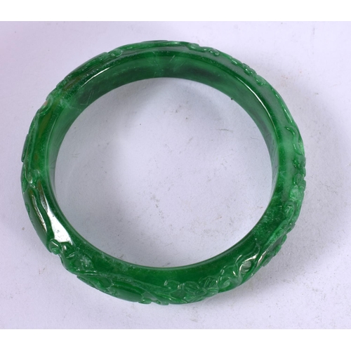 1329 - A CHINESE CARVED JADE BANGLE. 53 grams. 6 cm wide.