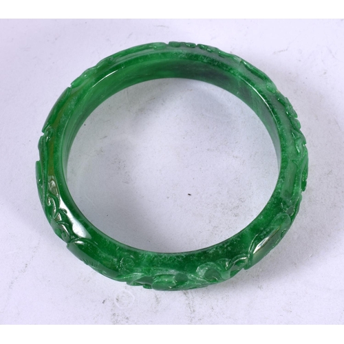 1329 - A CHINESE CARVED JADE BANGLE. 53 grams. 6 cm wide.