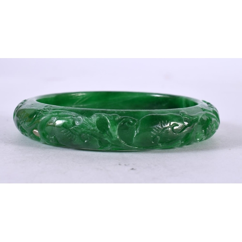 1329 - A CHINESE CARVED JADE BANGLE. 53 grams. 6 cm wide.