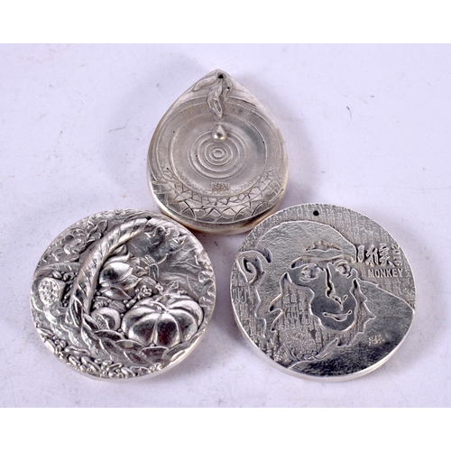 1335 - THREE CHINESE WHITE METAL PENDANTS. 193 grams. 4.5 cm wide. (3)