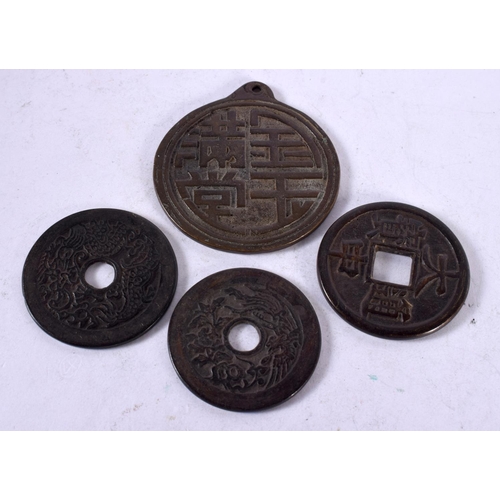 1342 - FOUR CHINESE BRONZE COINS. 118 grams. Largest 6.25 cm x 5.75 cm. (4)