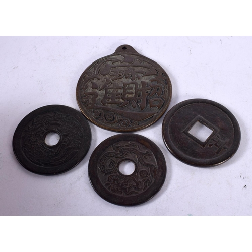 1342 - FOUR CHINESE BRONZE COINS. 118 grams. Largest 6.25 cm x 5.75 cm. (4)