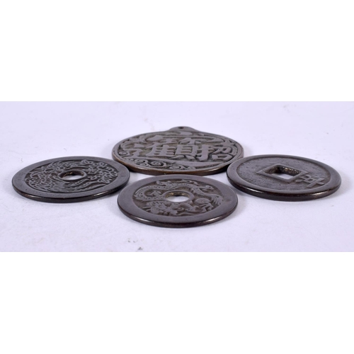 1342 - FOUR CHINESE BRONZE COINS. 118 grams. Largest 6.25 cm x 5.75 cm. (4)