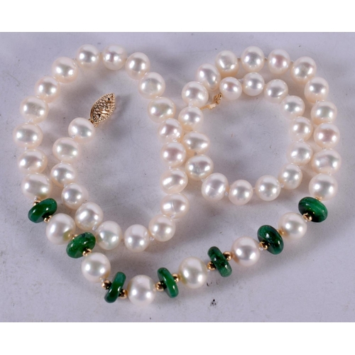 1344 - A STRING OF 14CT GOLD JADE AND PEARLS. 32 grams. 44 cm long.