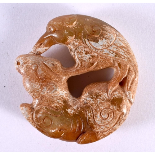 1393 - A JADE ROUNDEL CARVED WITH FISH.  5cm x 1.3cm, weight 46g