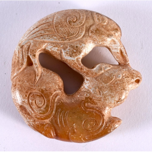 1393 - A JADE ROUNDEL CARVED WITH FISH.  5cm x 1.3cm, weight 46g