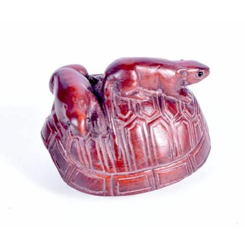 1438 - A CARVED WOOD NETSUKE IN THE FORM OF TWO RATS CLIMBING OVER A TURTLE SHELL.  4.4cm x 3.5cm x 3.3cm, ... 