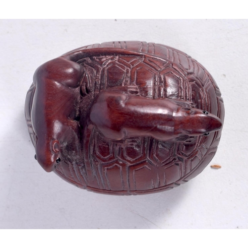 1438 - A CARVED WOOD NETSUKE IN THE FORM OF TWO RATS CLIMBING OVER A TURTLE SHELL.  4.4cm x 3.5cm x 3.3cm, ... 