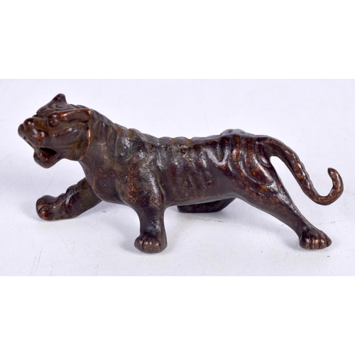 1439 - A BRONZE MODEL OF A TIGER.  7.7cm x 4cm x 3cm, weight 93.5g