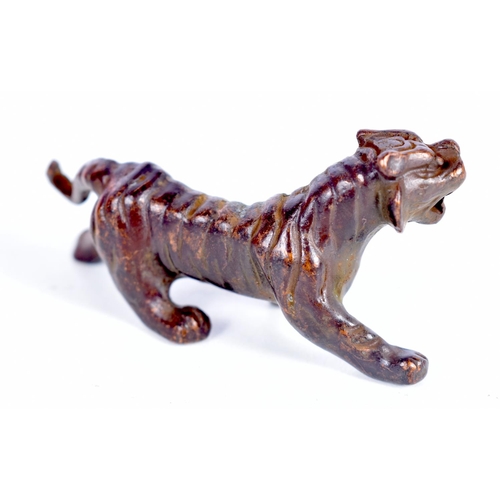 1439 - A BRONZE MODEL OF A TIGER.  7.7cm x 4cm x 3cm, weight 93.5g