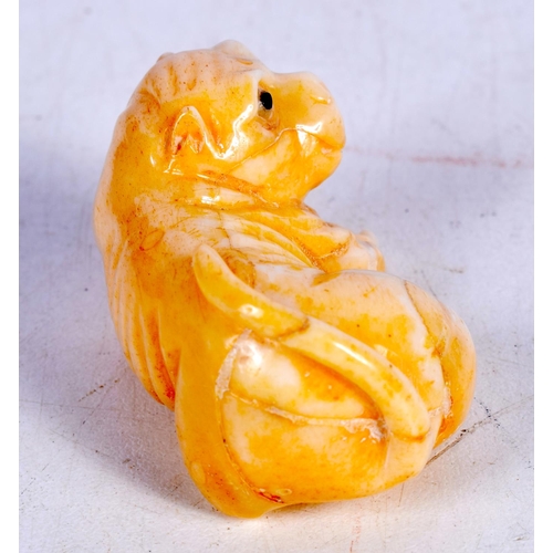 1440 - A BONE CARVING OF A DOG.  2.7cm x 5cm x 2.9cm, weight 34g