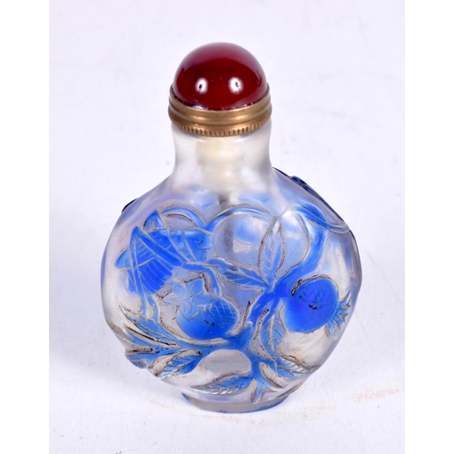 1442 - A PEKING GLASS SNUFF BOTTLE OVERLAID WITH BLUE GLASS FLOWERS.  7.5cm x 4.9cm x 2.7cm, weight 73g