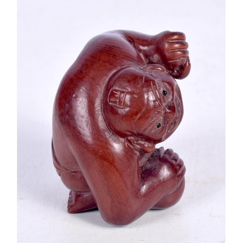 1444 - A JAPANESE CARVED HARDWOOD FIGURE OF A CROUCHING MALE.  5.3cm x 4.5cm x 5.1cm, weight 37.3g