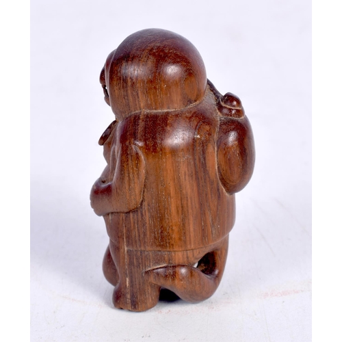 1445 - A JAPANESE CARVED HARDWOOD FIGURE OF A HOODED MONKEY WITH A SACK ON HIS BACK.  5.3cm x 3.2 cm x 3.2 ... 