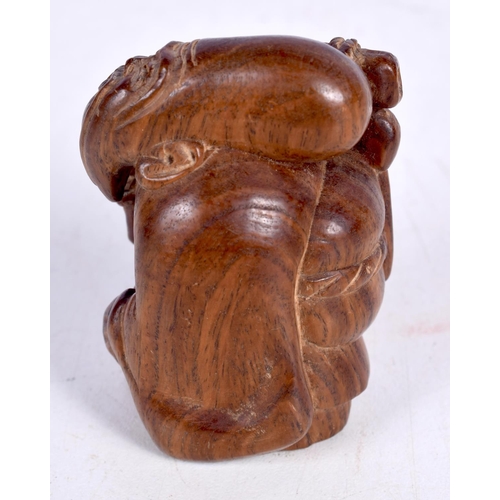 1447 - A JAPANESE CARVED HARDWOOD FIGURE OF AN OLD MAN STIRRING A COOKING POT.  5.4cm x 3.5cm x 3cm, weight... 