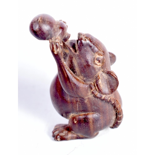 1449 - A JAPANESE CARVED HARDWOOD FIGURE OF A RAT DRINKING FROM A GOURD.  5cm x 2.8 cm x 2.5cm, weight 18.2... 