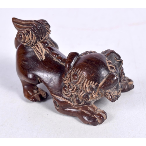 1450 - A JAPANESE CARVED HARDWOOD FIGURE OF A TEMPLE DOG.  3.4cm x 5.6 cm x 3.4cm, weight 20.8g